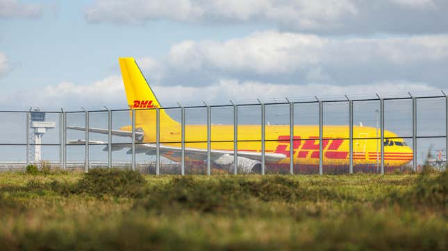 A cargo airplane of the DHL package delivery company stands on the tarmac at Leipzig/Halle Airport on October 15, 2024 in Schkeuditz, Germany. 