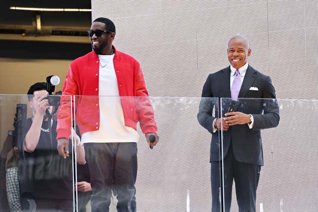 New York Mayor Eric Adams (R) presents Sean “Diddy” Combs with the keys to the city in Times Square on September 15, 2023 in New York City.