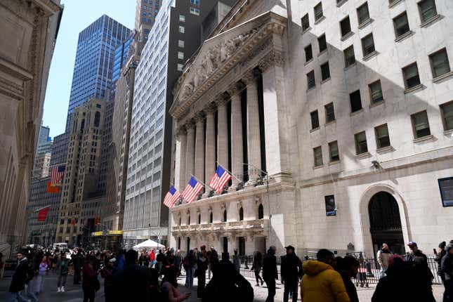 FILE - Pedestrians walk past the New York Stock Exchange building on March 25, 2024, in New York. Global shares have mostly declined on Friday, April 5, 2024, as investors looked to a key U.S. jobs report due later in the day to gauge the health of the economy and see what the Federal Reserve might do on interest rates. (AP Photo/Frank Franklin II, File)