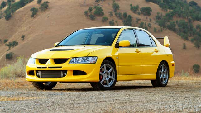 Front quarter view of a Mitsubishi Lancer Evolution VIII parked in front of a hill