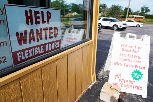 FILE - A &quot;Help Wanted&quot; sign is displayed in Deerfield, Ill., Wednesday, Sept. 21, 2022. The year looks to be a much better one for the U.S. economy than business economists were forecasting just a few months earlier, according to a survey released Monday, Feb. 26, 2024. (AP Photo/Nam Y. Huh)