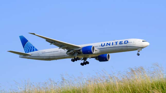 A United Airlines Boeing 777 landing at an airport