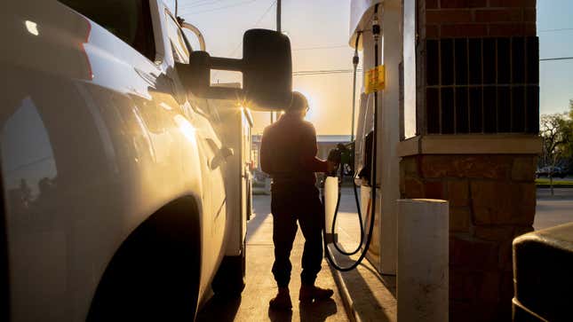 A photo of someone filling up a truck at a gas station in the USA.