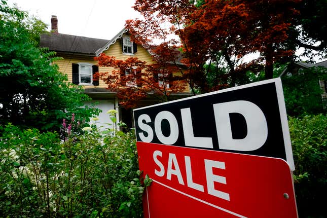 FILE - A sale sign stands outside a home in Wyndmoor, Pa., Wednesday, June 22, 2022. The National Association of Realtors has agreed on Friday, March 15, 2024, to pay $418 million and change its rules to settle lawsuits claiming homeowners have been unfairly forced to pay artificially inflated agent commissions when they sold their home. (AP Photo/Matt Rourke, File)