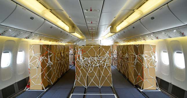 The inside of a Boeing 777-300 jet with the seats stripped away and replaced by strapped-down boxes of cargo.