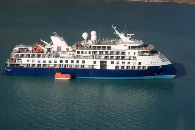 An aerial photo shows the Ocean Explorer, a Bahamas-flagged Norwegian cruise ship with 206 passengers and crew, which has run aground in northwestern Greenland, on Tuesday, Sept. 12, 2023. The 104.4-meter (343-foot) long and 18-meter (60 foot) wide Ocean Explorer ran aground on Monday in Alpefjord in the Northeast Greenland National Park. It&#39;s the world’s largest and most northerly national park and is known for icebergs and the musk oxen that roam the coast. According to authorities no one on board was in danger and no damage has been reported. (Danish Air Force/Joint Arctic Command via AP)