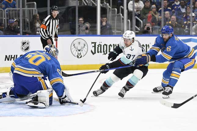 Oct 14, 2023; St. Louis, Missouri, USA; St. Louis Blues goaltender Jordan Binnington (50) and defenseman Marco Scandella (6) defend the net from Seattle Kraken center Yanni Gourde (37) during the first period at Enterprise Center.