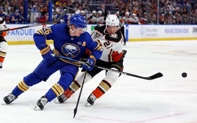 Feb 19, 2024; Buffalo, New York, USA;  Buffalo Sabres defenseman Rasmus Dahlin (26) clears the puck as Anaheim Ducks center Isac Lundestrom (21) defends during the first period at KeyBank Center.