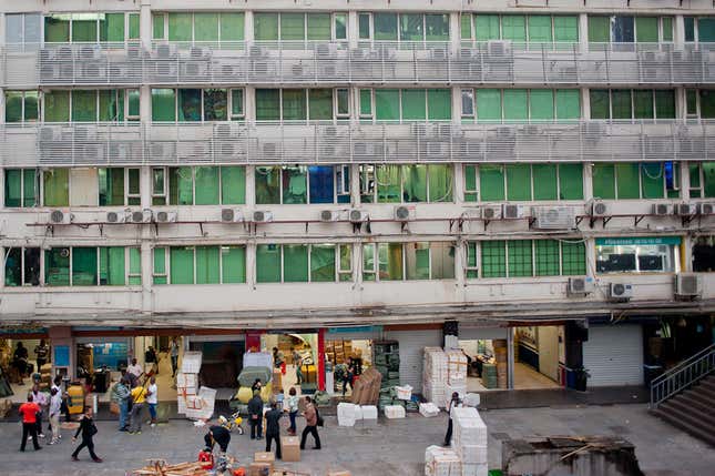 A building full of merchants, shippers and money-transfer services serving African traders. Merchants from Nigeria, Ivory Coast, and Ghana started moving to south China from more established trading hubs like Indonesia and Thailand, after currencies tanked during the Asian financial crisis of the late 1990s.