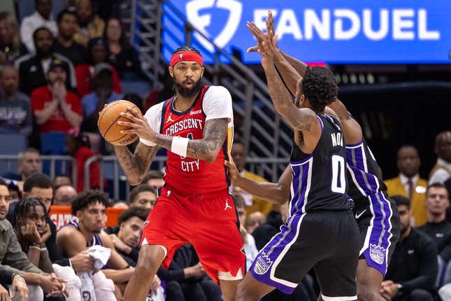 Nov 20, 2023; New Orleans, Louisiana, USA;  New Orleans Pelicans forward Brandon Ingram (14) looks to pass the ball against Sacramento Kings guard Malik Monk (0) during the second half at the Smoothie King Center.