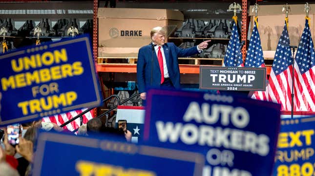 Former president Donald Trump points at Drake Enterprises in Clinton Township, Michigan on September 27, 2023. 