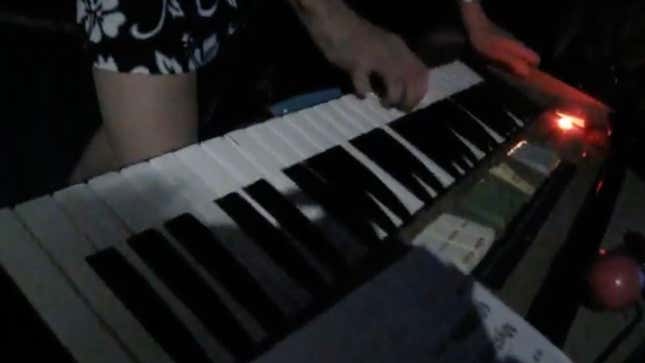 A screenshot of someone playing the piano. 