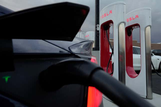 FILE - A vehicle charges at a Tesla Supercharger station in Detroit, Nov. 16, 2022. Owners of Ford electric vehicles can now use much of Tesla&#39;s charging network in the U.S. and Canada, but there&#39;s a hitch: they&#39;ll need to get an adapter that Ford will provide for free, although the company won&#39;t start shipping those until the end of March 2024. (AP Photo/Paul Sancya, File)