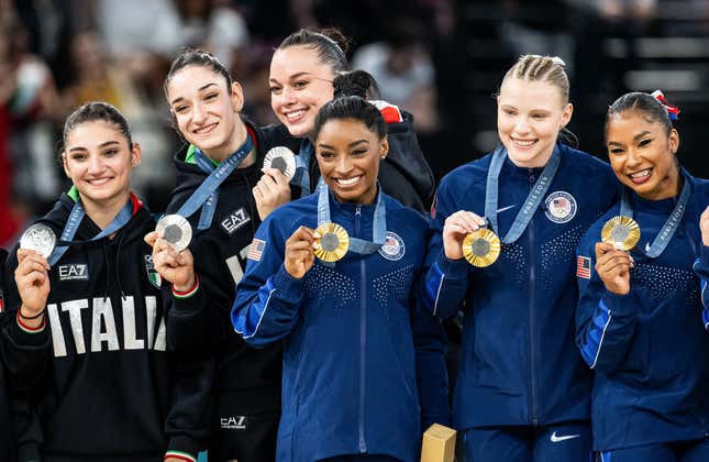 Simone Biles de EE. UU. (C) celebra la victoria con su equipo y el equipo de Italia en el cuarto día de los Juegos Olímpicos de París 2024. 