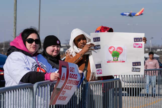 People protest ride-hailing companies like Uber, Lyft and others in the Transportation Network Provider parking lot at O&#39;Hare International Airport, Wednesday, Feb. 14, 2024, in Chicago. (AP Photo/Erin Hooley)