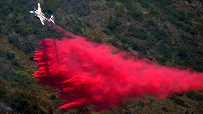 A plane drops fire retardant onto the Coastal Fire on Thursday, May 12, 2022, in Laguna Niguel, Calif.
