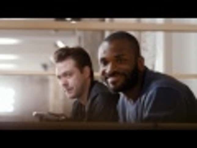 Two Men Direct a Real Game of Football With a Video Game Controller