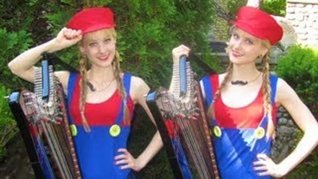 Blonde Twins Playing <em>Mario</em> Music On Harps In Front Of A Castle