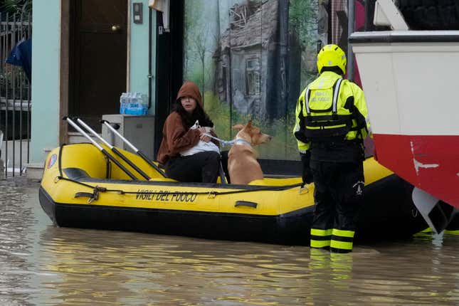 Firefighters rescue a resident in Campi di Bisenzio, in the central Italian Tuscany region, Friday, Nov. 3, 2023. Record-breaking rain provoked floods in a vast swath of Tuscany as storm Ciaran pushed into Italy overnight Friday, trapping people in their homes, inundating hospitals and overturning cars. At least three people were killed, and four were missing. (AP Photo/Gregorio Borgia)