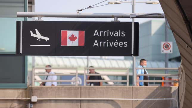 Travelers walk at Toronto Pearson International Airport