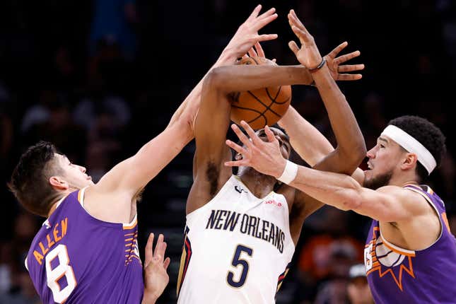PHOENIX, ARIZONA - APRIL 07: Grayson Allen #8 and Devin Booker #1 of the Phoenix Suns pressure Herbert Jones #5 of the New Orleans Pelicans during the second half at Footprint Center on April 07, 2024 in Phoenix, Arizona. NOTE TO USER: User expressly acknowledges and agrees that, by downloading and or using this photograph, User is consenting to the terms and conditions of the Getty Images License Agreement. (Photo by Chris Coduto/Getty Images)