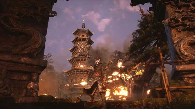 A man stands in front of a burning building, viewed through a giant arch.