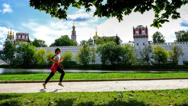 A woman jogs near the Novodevichy Convent in central Moscow on September 14, 2020. 