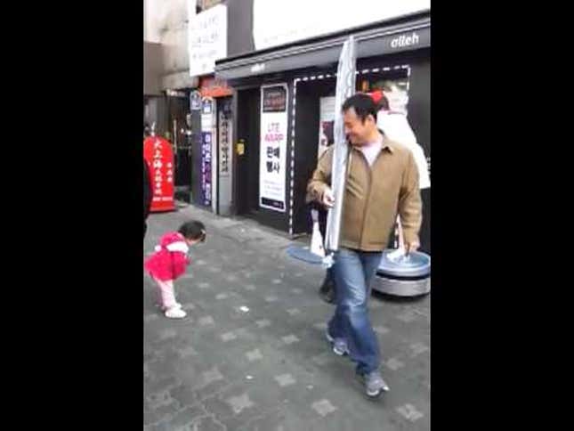Adorable Little Girl Practices Bowing with a Korean Robot