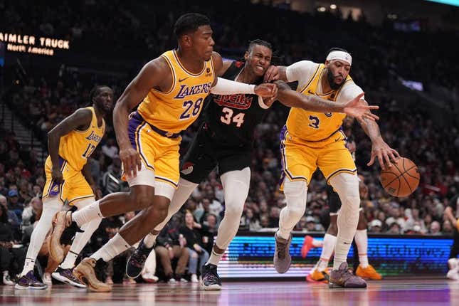 Nov 17, 2023; Portland, Oregon, USA; Portland Trail Blazers forward Jabari Walker (34) and Los Angeles Lakers power forward Rui Hachimura (28) and Anthony Davis (3) go after a loose ball during the first half at Moda Center.