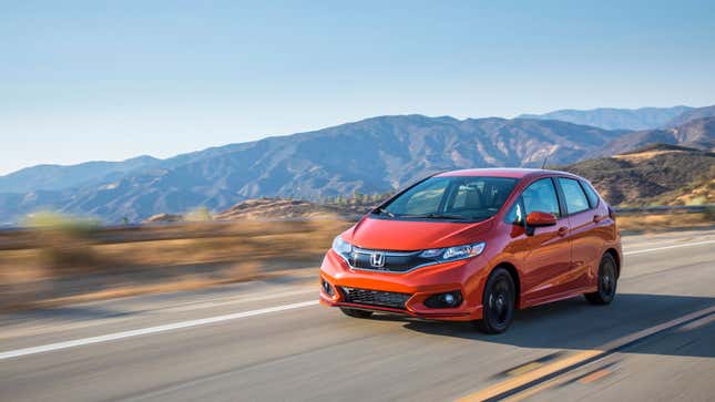 A photo of a red Honda Fit hatchback. 