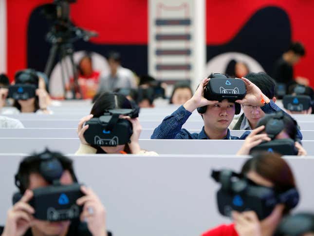 Reporters experience a VR shopping service during the Alibaba Group's 11.11 Global shopping festival, in Shenzhen, Guangdong province, China November 11, 2016.