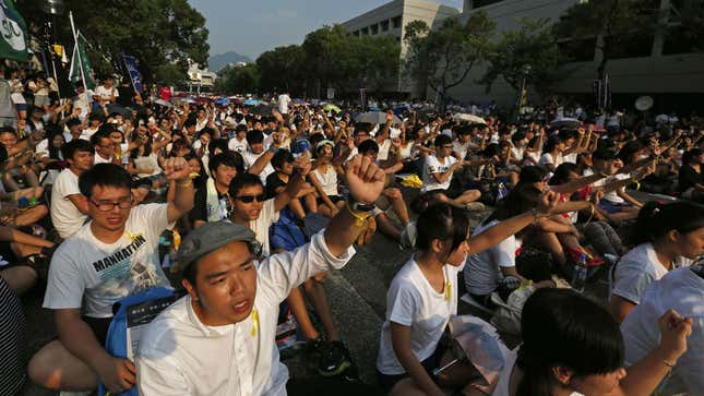 Students from various universities chant slogans at the Chinese University in Hong Kong September 22, 2014. Thousands of students braved sweltering heat in Hong Kong on Monday to demand greater democracy as they launched a week-long boycott of classes,