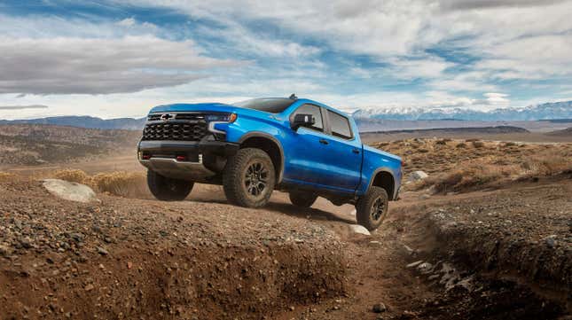 A blue Chevy Silverado traversing terrain