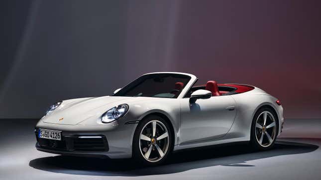 A white Porsche 911 cabriolet shot in a studio 