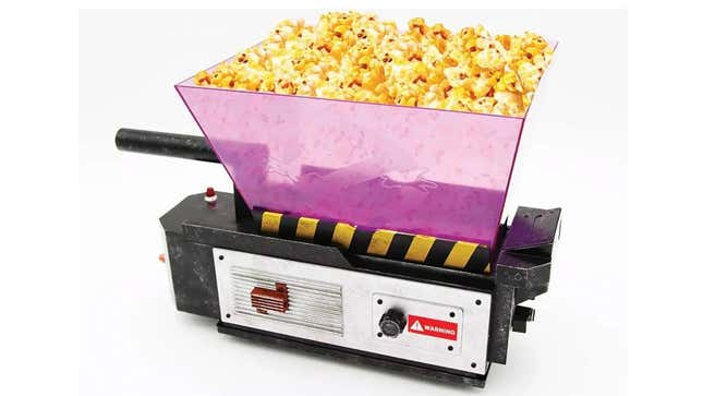 A Ghostbusters trap with popcorn sitting in a pink bucket atop it that is likely meant to suggest the dazzling light that emerges from an open ghost trap in the films.