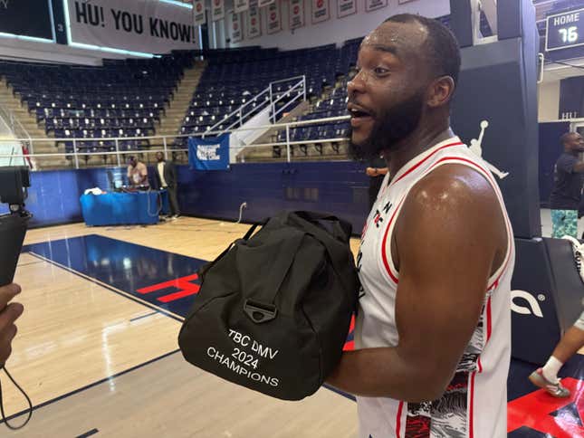 Joe Bryant Jr., former MEAC player of the year, holds the 30,000 BTC prize bag after winning The Bitcoin Classic DMV.