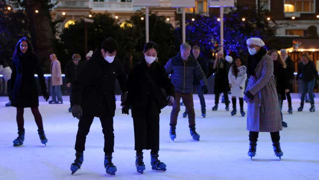 Skaters on the ice rink at the Natural History Museum in central London on December 9, 2021. 