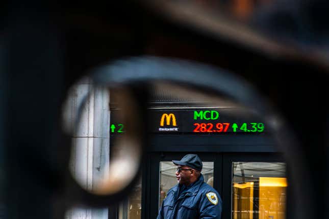 A Security member stands guard at one of the entrance of the New York Stock Exchange in New York, Tuesday, March 19, 2024. (AP Photo/Eduardo Munoz Alvarez)