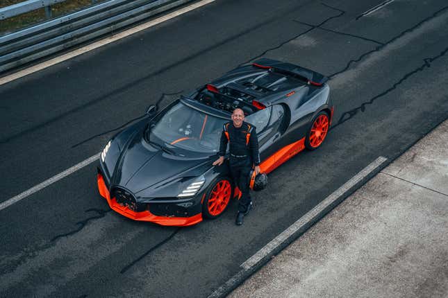 Front 3/4 view of the black and orange Bugatti W16 Mistral World Record Car with Andy Wallace