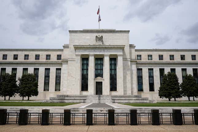 FILE - An American flag flies over the Federal Reserve building on May 4, 2021, in Washington. In statements made Thursday, Feb. 22, 2024, several Federal Reserve policymakers warned against cutting U.S. interest rates too soon or by too much in the wake of recent data showing inflation stayed unexpectedly high in January. (AP Photo/Patrick Semansky, File)