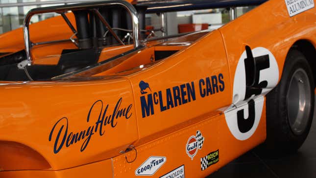 A close up photo of the orange colored Can Am car driven by Bruce McLaren 