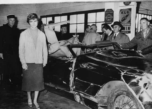 Playwright Francoise Sagan posing next to a badly damaged car, as part of a reconstruction of her recent car crash by the investigative authorities, Milly La Foret, Paris, 1957