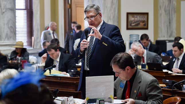 File-This March 2019 file photo shows State Rep. Brad Tschida, R-Missoula, speaking on the floor of the state House in Helena, Mont. The fight between moderate and conservative factions within the Montana Republican Party seeking to control the GOP's legislative agenda led to the defeat of incumbents and experienced lawmakers in this week's primary elections. (Thom Bridge/Independent Record via AP, File)