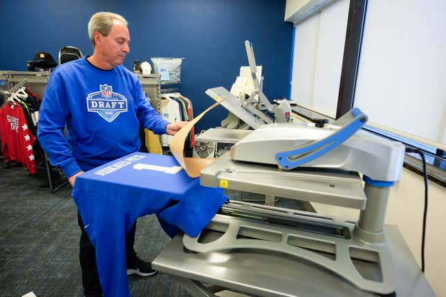 Brent Kisha, STAHLS&#39; vice president of strategic sales, demonstrates using a Hotronix Fusion IQ heat press to put a name on shirt in St. Clair Shores, Mich., Monday, April 22, 2024. STAHLS&#39; rapidly personalizes jerseys for each first-round pick as they are announced at the NFL draft. (AP Photo/Paul Sancya)