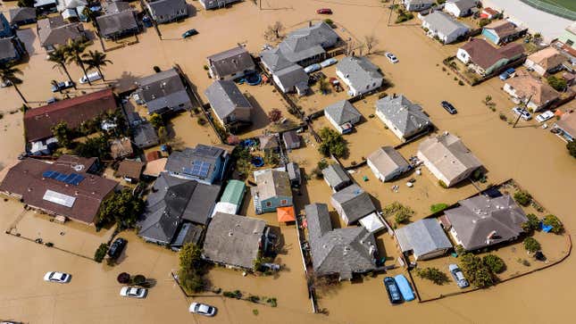 Floodwaters surround homes and vehicles in the community of Pajaro in Monterey County, California on March 13, 2023.