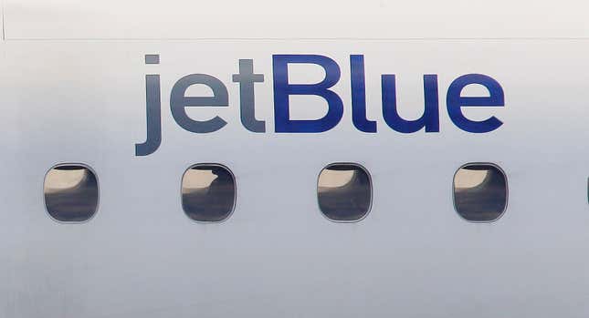 FILE - In this Jan. 20, 2011, file photo, a JetBlue logo is displayed on the side of a jet as it taxis at Boston&#39;s Logan International Airport. Federal investigators are describing a close call between planes at a Colorado airport last year. The National Transportation Safety Board said Wednesday, Dec. 13, 2023 that a JetBlue plane struck its tail on the ground because the captain took off quickly to avoid a plane that was preparing to land on the same runway. (AP Photo/Stephan Savoia, File)