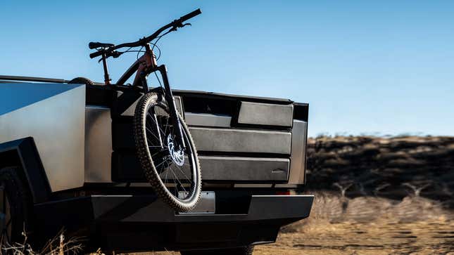 Image for article titled Tesla&#39;s New $300 Cybertruck Tailgate Pad Protects Your &#39;Bulletproof&#39; Truck From Big Scary Bicycles