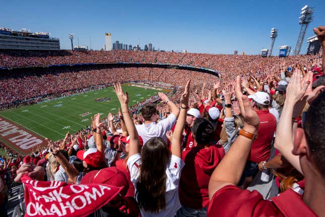 Oklahoma fans celebrate a touchdown during the first half of an NCAA college football game against Texas at the Cotton Bowl, Saturday, Oct. 7, 2023, in Dallas. The ESPN “College GameDay” analyst Kirk Herbstreit and the network&#39;s broadcaster Chris Fowler announced Thursday, Feb. 22, 2024, on social media they will be voices in EA Sports&#39; upcoming college football video game. (AP Photo/Jeffrey McWhorter, File)