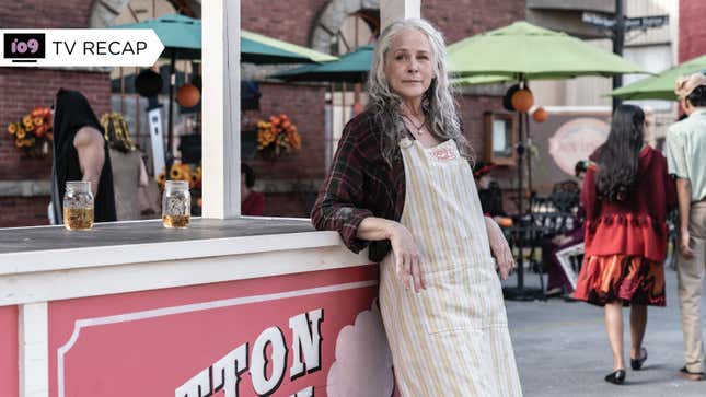 Carol wears an apron and leans on a cotton candy cart in a scene from The Walking Dead.