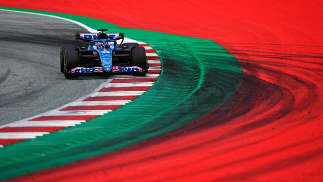 A photo of Fernando Alonso racing his Alpine F1 car in Austria. 